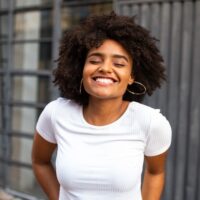happy black woman smiling eyes closed