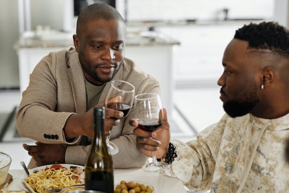 Black men drinking and enjoying wine